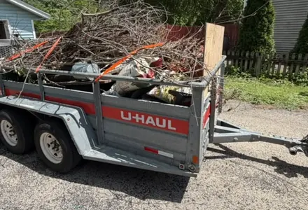Trailer loaded with brush, branches and yard debris